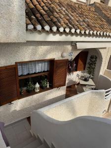 an external view of a building with a table and chairs at Estudio San Marcos 17 in La Manga del Mar Menor