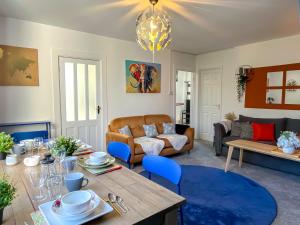 a living room with a table and a couch at ColleyHouse-private parking-business-group-relocation-SpaciousStylish 4BRHome-Sleeps 10 in Sheffield
