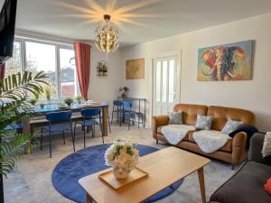 a living room with a couch and a table at ColleyHouse-private parking-business-group-relocation-SpaciousStylish 4BRHome-Sleeps 10 in Sheffield