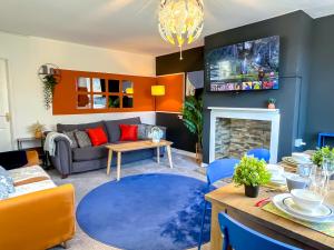 a living room with a couch and a table at ColleyHouse-private parking-business-group-relocation-SpaciousStylish 4BRHome-Sleeps 10 in Sheffield