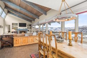 a dining room with a table and views of mountains at Oak Ridge Retreat by Snowmass Vacations in Snowmass Village