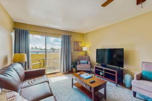 a living room with a couch and a flat screen tv at Camelback House in Scottsdale