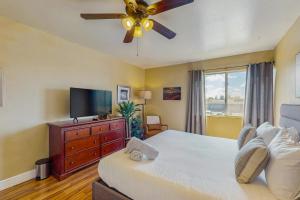a bedroom with a bed with a ceiling fan and a television at Camelback House in Scottsdale +13 photos
