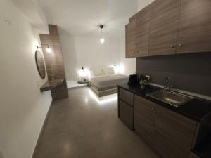 a kitchen with a sink and a bed in a room at Litmus in Fira +69 photos