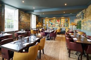 a restaurant with tables and chairs in a room at The Kings Arms in Christchurch