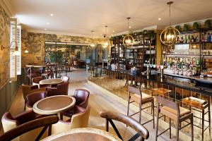 a restaurant with tables and chairs and a bar at The Kings Arms in Christchurch