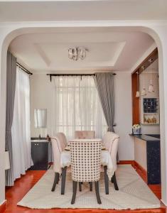 a dining room with a table and chairs at Lake duluti serenity villas in Arusha