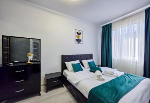 Postel nebo postele na pokoji v ubytování Joy Residence