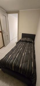 a large bed in a bedroom with a door at La Casetta in Pescolanciano