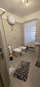 a bathroom with a toilet and a sink at La Casetta in Pescolanciano +10 photos