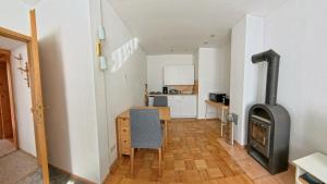 a kitchen and dining room with a wood stove at Ferienwohnung Struth-Helmershof in Struth-Helmershof