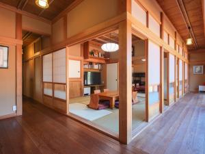 a living room with a table and a large window at 薬医門の宿 in Katori