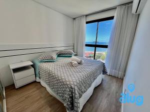 a bedroom with a bed and a large window at Vista Mar Próximo ao Beto Carrero - Cond. Club in Piçarras +54 photos