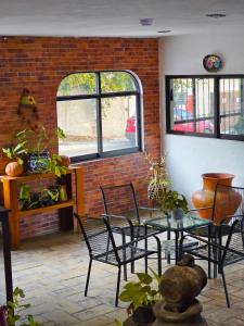 a room with tables and chairs and a brick wall at Hotel Villa Esmeralda in Tuxtla Gutiérrez +13 photos