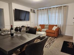 a living room with a table and a couch at Dmltd in Northampton