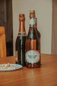 two bottles on a table with a plate of peanuts at victorious chillzone hostel in Nkoanrua
