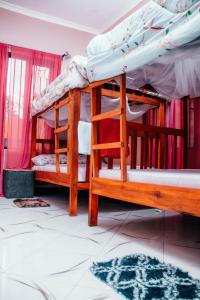 a couple of bunk beds in a room at victorious chillzone hostel in Nkoanrua