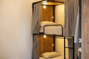 a room with three bunk beds in a room at Meridiano Hostel Boutique in Buenos Aires