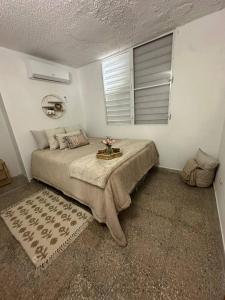 a bedroom with a large bed and a window at A1-tg Family Oriented Stay in Caguas