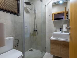 a bathroom with a shower and a toilet and a sink at The Zlatibor Chalet in Zlatibor +19 photos