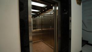 a glass door in a room with a hallway at Arzum in Tashkent