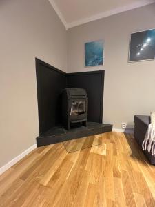 a living room with a fireplace with a stove at Eidfjord Fjell in Eidfjord +31 photos