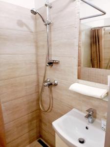 a bathroom with a shower and a sink at Brick Lane Apartment in Gdańsk +5 photos