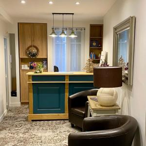 a living room with a bar with two chairs and a table at Hotel Solara in Nice