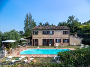 an external view of a house with a swimming pool at La Girolima 6&2 by Marche Holiday Villas in Mondavio
