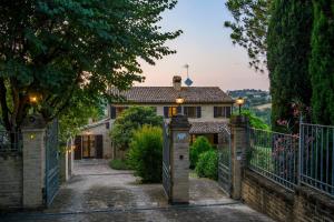 a house with a gate in front of it at La Girolima 6&2 by Marche Holiday Villas in Mondavio