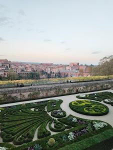a view of a garden with a city in the background at Ô petit cocon in Albi +6 photos