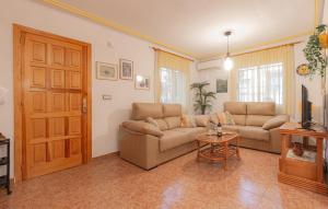a living room with a couch and a table at Urb Al Andalus I in Villamartin