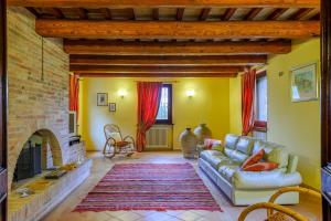 a living room with a couch and a fireplace at Villa Emilianna 12&2 by Marche Holiday Villas in Fano