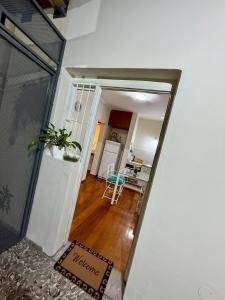 a hallway leading into a living room with a kitchen at Shanti Loft in San Juan +4 photos