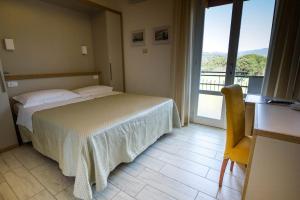 Postel nebo postele na pokoji v ubytování Hotel Mirella