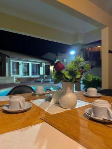 a table with a vase of flowers on top of it at Dithabeng View Guest House in Rustenburg