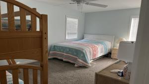 a bedroom with a bed and a ceiling fan at Pavloski in Beach Haven
