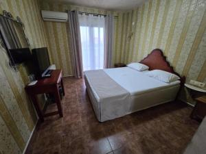 Postel nebo postele na pokoji v ubytování Boutique Hotel Colosseo