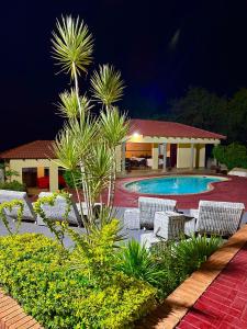 a resort with chairs and a swimming pool at night at Dithabeng View Guest House in Rustenburg
