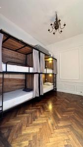 a room with two bunk beds and a wooden floor at Meridiano Hostel Boutique in Buenos Aires