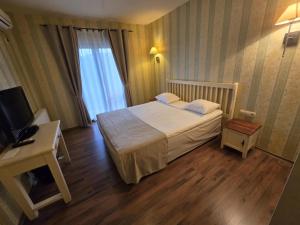 Postel nebo postele na pokoji v ubytování Boutique Hotel Colosseo