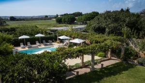 an overhead view of a swimming pool with umbrellas at Historic building with pool in Gagliano del Capo