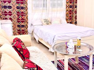 ein Wohnzimmer mit einem Bett und einem Tisch in der Unterkunft Boho Oasis Studio Hurghada Red Sea in Hurghada