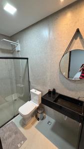 a bathroom with a toilet and a mirror at Casa Villages Piranhas in Piranhas +6 photos
