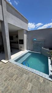 a swimming pool in front of a house at Casa Villages Piranhas in Piranhas
