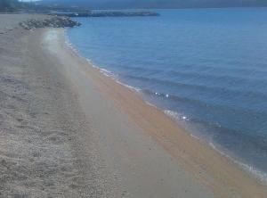 a beach with rocks and the ocean with at Apartments Lana in Zadar
