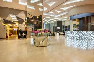 a lobby with a flower display in a building at Best Western Plus Doha in Doha