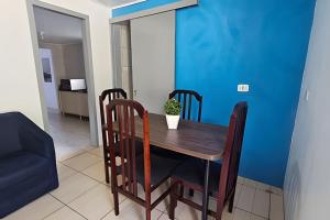 a dining room table with chairs and a blue wall at Casa de Campo em Bento Gonçalves in Bento Gonçalves +9 photos