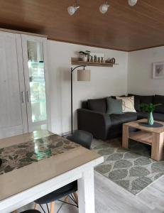 a living room with a couch and a table at Zum Rosenhügel in Hellenthal