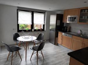 a kitchen with a table and chairs in a kitchen at Zum Rosenhügel in Hellenthal